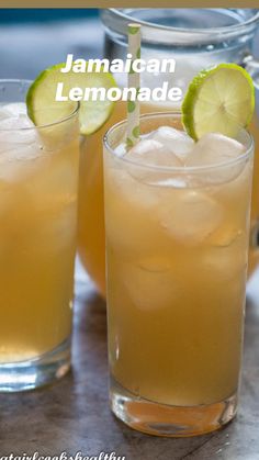 two glasses filled with lemonade sitting on top of a table