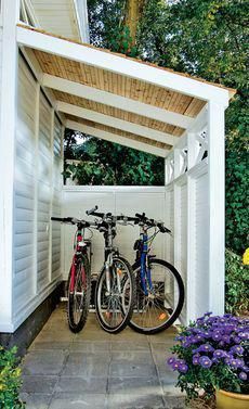 two bikes are parked under a pergolated area