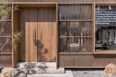 a store front with wooden doors and windows