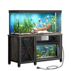 an aquarium with fish and plants in it on top of a stand next to a wall