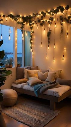 a living room filled with furniture and lots of lights hanging from the ceiling above it