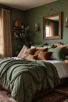 a bed with green sheets and pillows in a bedroom next to a mirror on the wall