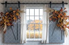 the window is decorated with fall leaves