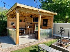 an outdoor kitchen is built into the side of a shed