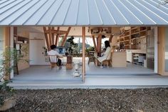 two people sitting at a table under a metal roof