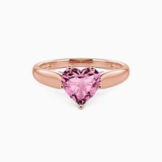 a pink heart shaped ring on a white background