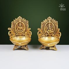 two golden statues sitting on top of each other