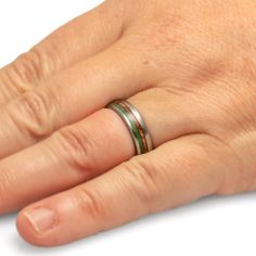 a person's hand with a ring on it