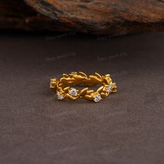 a gold ring with three diamonds on it