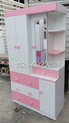 a pink and white dresser sitting in front of a truck