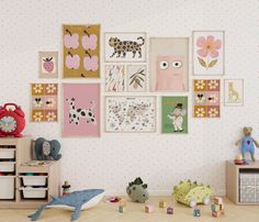 there are many pictures on the wall in this child's room, including toys