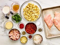 the ingredients are laid out on the counter to make this dish, including meats and vegetables