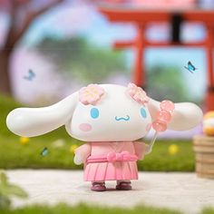 a small toy is standing in the grass with an umbrella and flowers on it's head