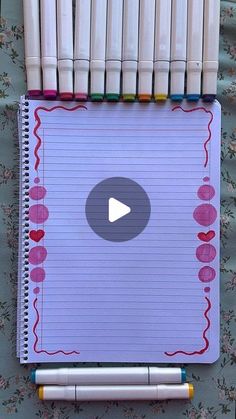 a notebook with crayons and markers on it