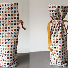 two bags with buttons on them are shown side by side, one is empty and the other has a yellow ribbon