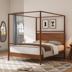 a bed sitting in a bedroom next to a table with a mirror on top of it