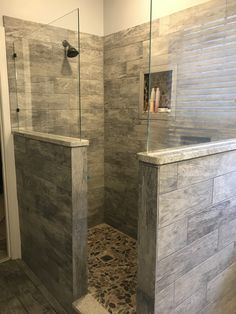 a walk in shower sitting inside of a bathroom