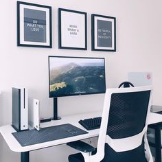 a computer desk with a monitor, keyboard and mouse next to pictures on the wall