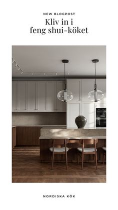 a large kitchen with wooden floors and white cabinetry, along with two pendant lights hanging from the ceiling