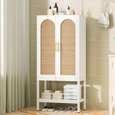 a white cabinet with wicker doors in a bathroom