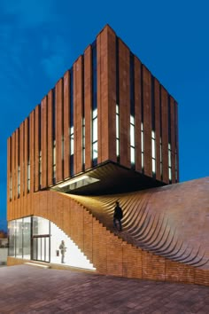 the building is made out of bricks and has stairs leading up to it's roof