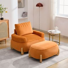 an orange chair and ottoman in a living room