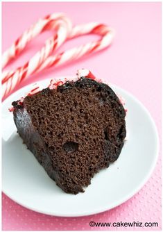 a slice of chocolate cake on a plate with candy canes