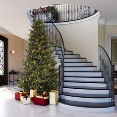 a christmas tree sitting in front of a staircase