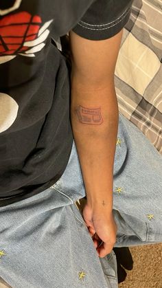 a person with a small tattoo on their arm