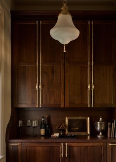 a kitchen with wooden cabinets and brass accents