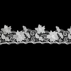 a white lace with flowers and leaves on it