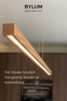 a wooden light fixture hanging from the ceiling in a kitchen with text overlay that reads bylum