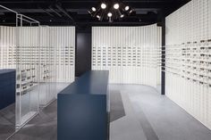 an empty room with rows of glasses on the wall