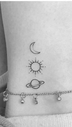 a woman's ankle with the sun and planets on it