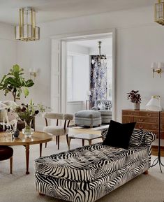 a living room filled with furniture and a zebra print couch