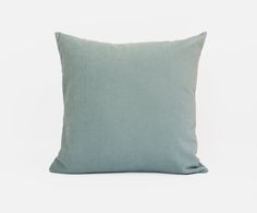 a light blue pillow on a white background