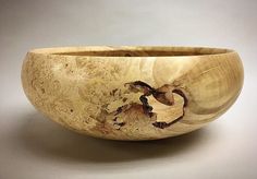 a wooden bowl sitting on top of a table