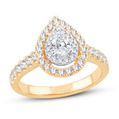 a yellow gold ring with a pear shaped diamond in the center and two rows of diamonds around it