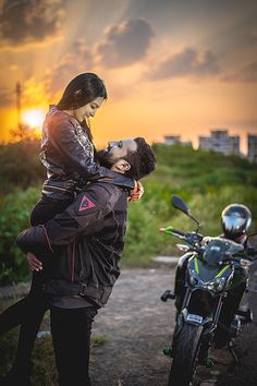 a man carrying a woman on his back while standing next to a motorcycle