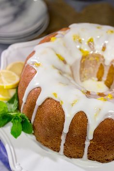 a bundt cake on a plate with lemons