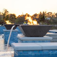 a fire pit sitting in the middle of a swimming pool