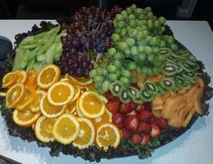 a platter filled with lots of different types of fruit