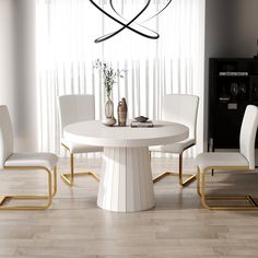 a white dining table with four chairs around it and a vase on the table next to it