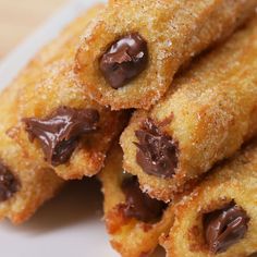 chocolate covered doughnuts stacked on top of each other