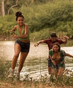 three young people are playing in the water