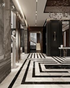 an elegant hallway with black and white marble flooring, chandelier and artwork