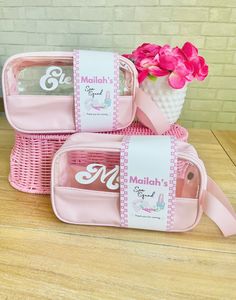 three pink baskets with flowers in them sitting on a table