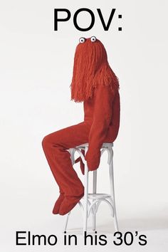 a person sitting on top of a white stool wearing an orange outfit with long hair