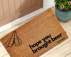 a door mat with the words hope you brought beer on it next to a potted plant