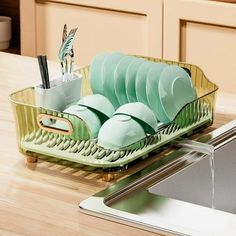 there is a dish rack with dishes in it